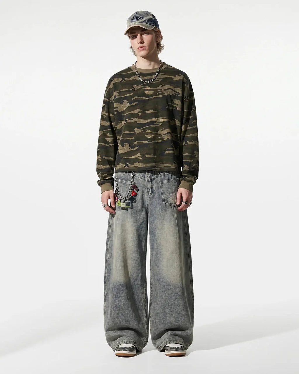 Distressed eyelet barrel jeans by Flation Streetwear featuring a relaxed fit and worn-in denim style.
