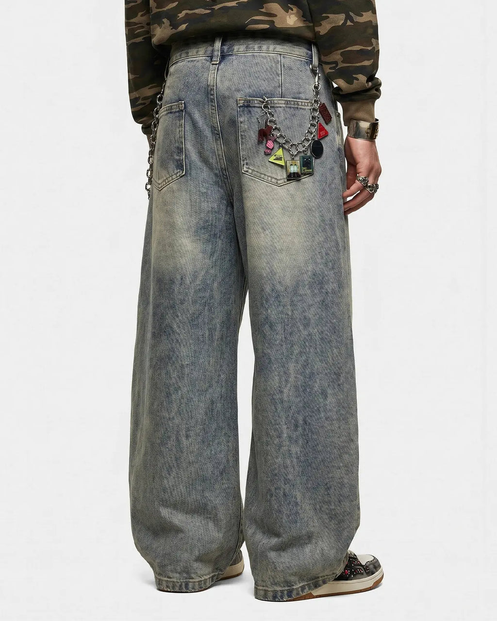Distressed eyelet barrel jeans by Flation Streetwear featuring a relaxed fit and ripped details on denim.