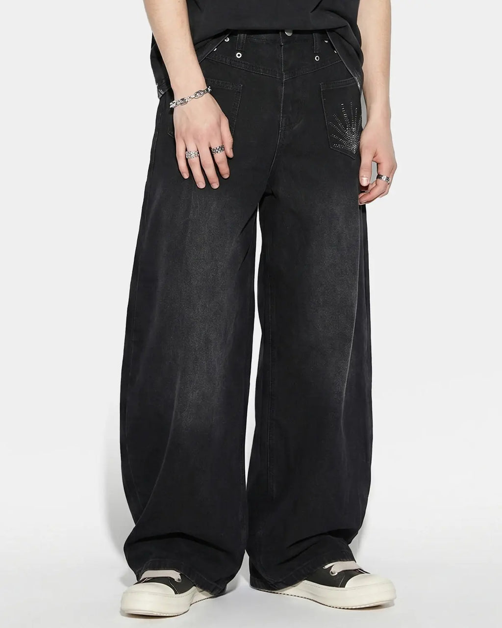 Distressed Eyelet Barrel Jeans by Flation Streetwear featuring ripped details and eyelet accents on classic denim.