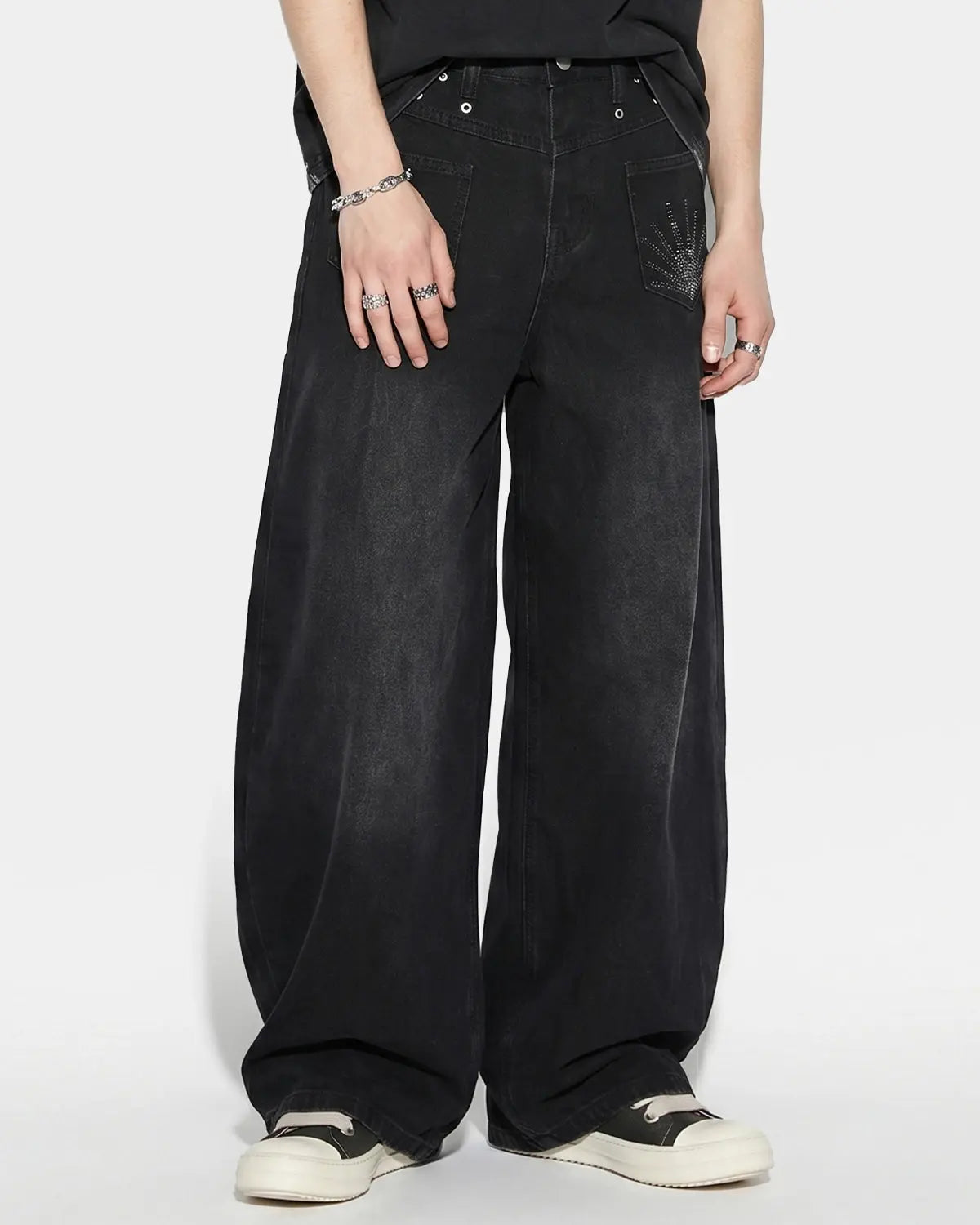 Distressed Eyelet Barrel Jeans by Flation Streetwear featuring ripped details and eyelet accents on classic denim.