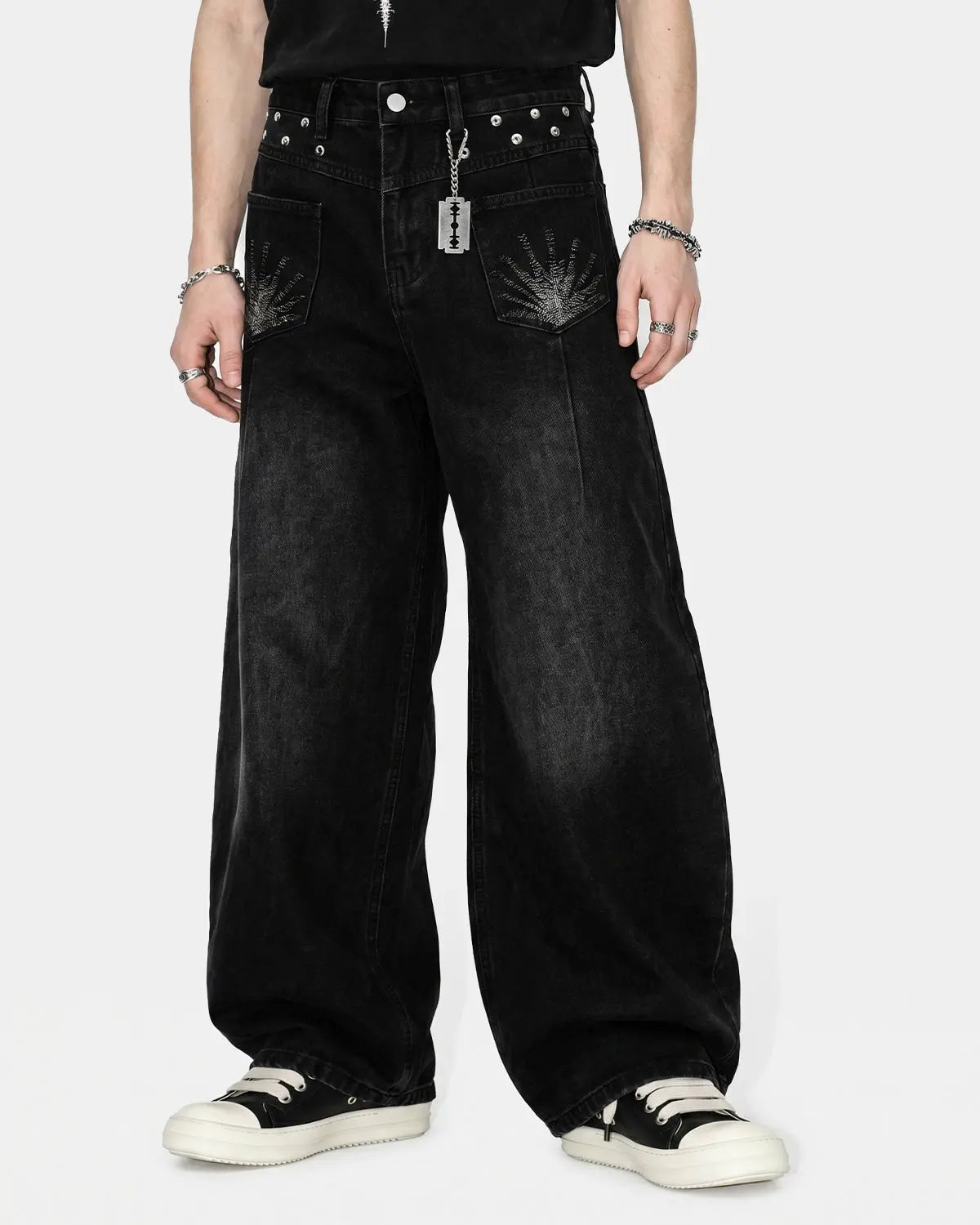 Distressed eyelet barrel jeans by Flation Streetwear featuring a relaxed fit, ripped details, and eyelet accents.