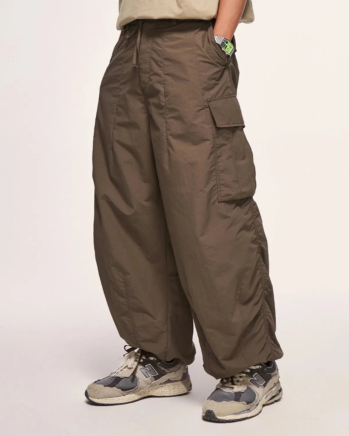 Black Flation Parachute Cargo Pants with relaxed fit and multiple pockets, stylish streetwear by Flation.