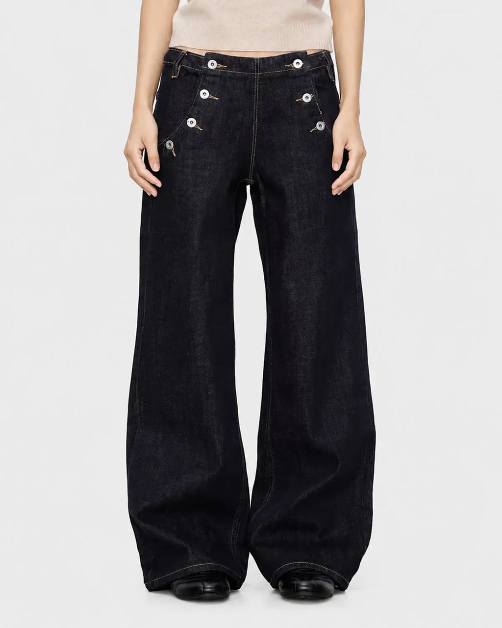 Black and blue wide-leg jeans with button details from Flation Streetwear, featuring a raw hem and relaxed fit.