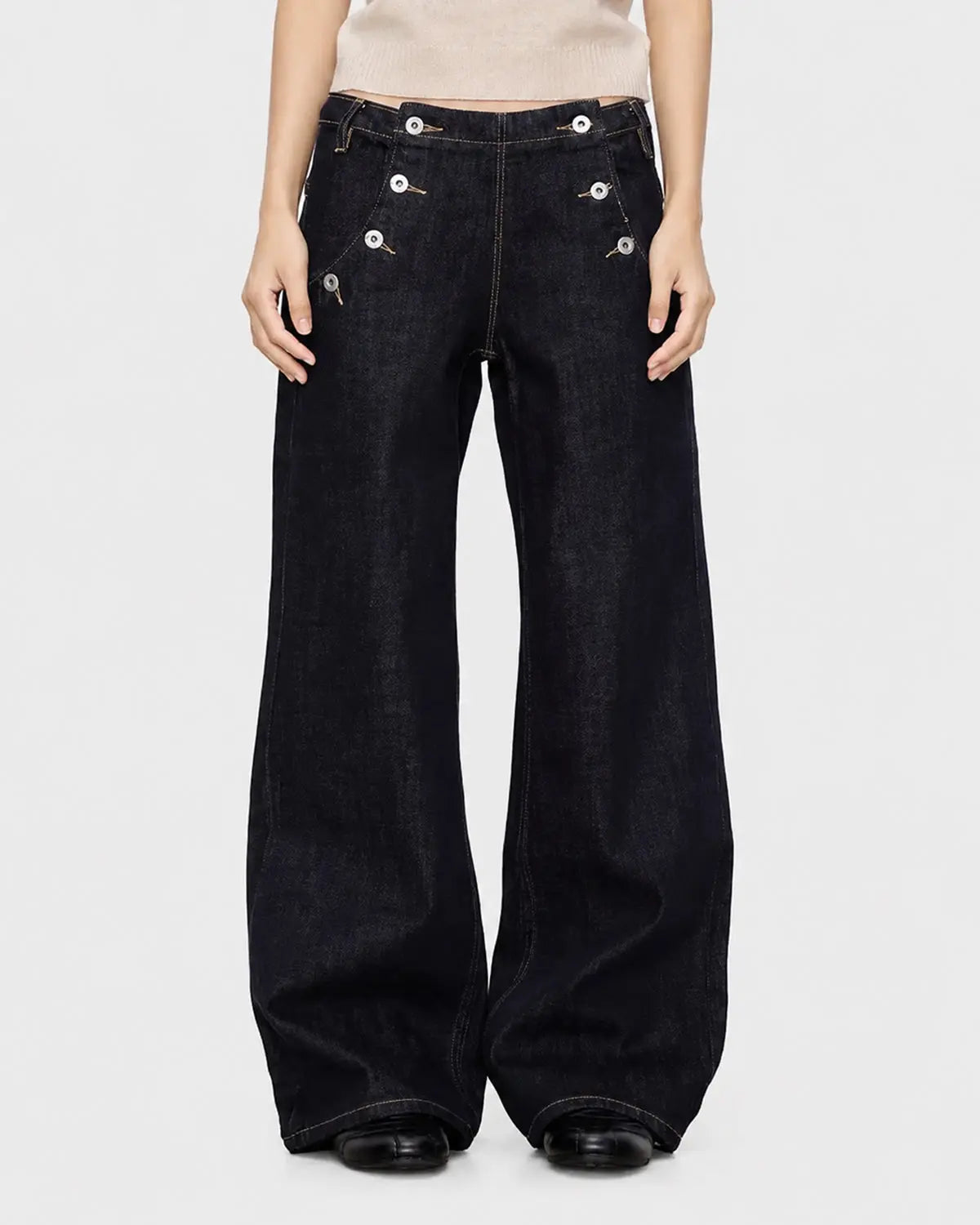 Black and blue wide-leg jeans with button details from Flation Streetwear, featuring a raw hem and relaxed fit.