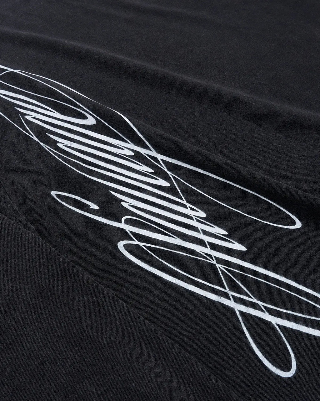 Black boxy fit graphic washed T-shirt by Flation Streetwear featuring bold script design on the front.
