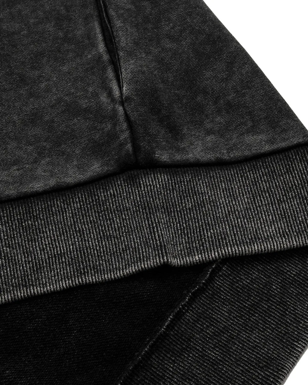Black distressed ribcage wash hoodie by Flation streetwear, featuring a relaxed fit and textured, vintage-style fabric.