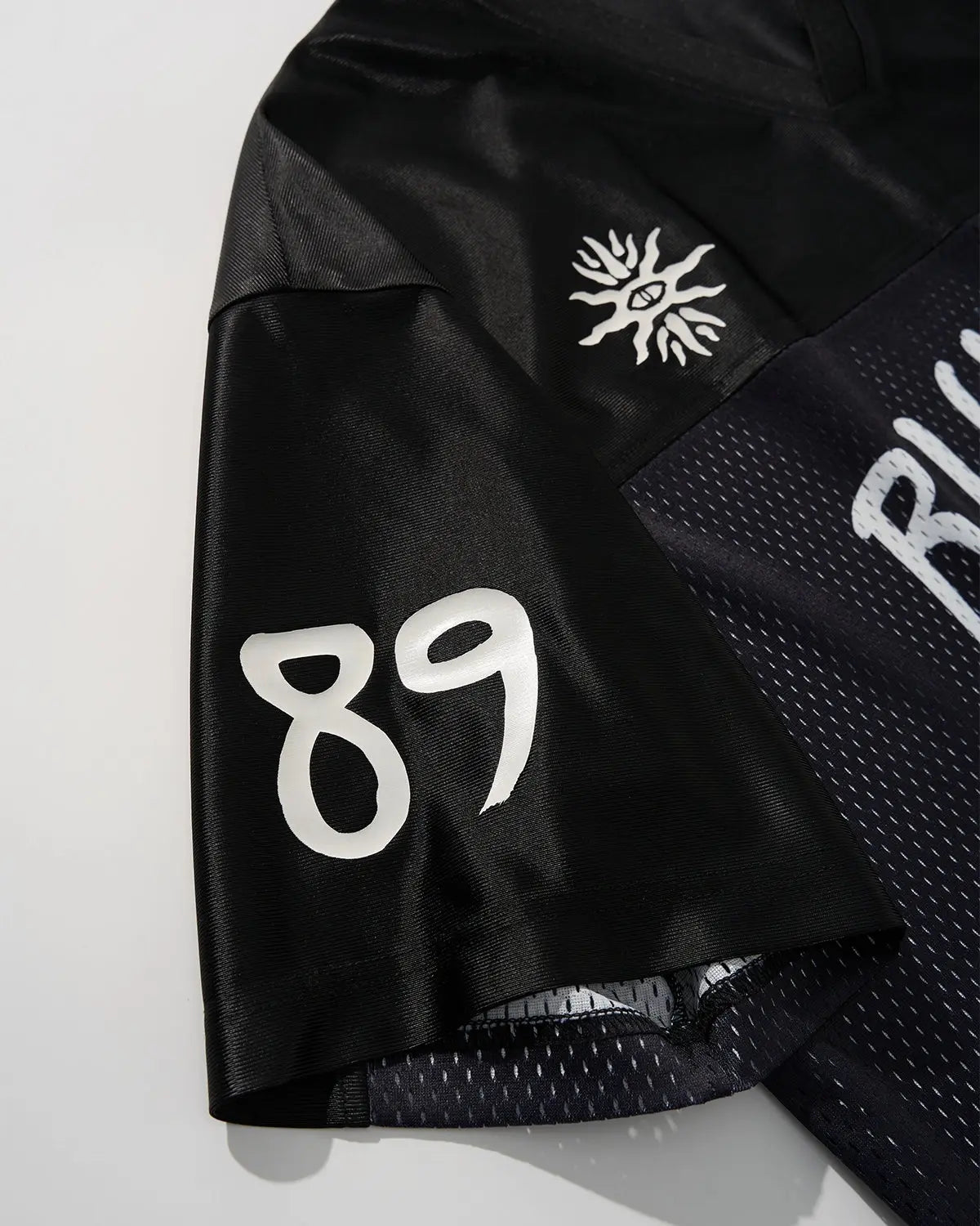 Black V-neck mesh patchwork jersey tee by Flation Streetwear, featuring a stylish mesh and patchwork design.