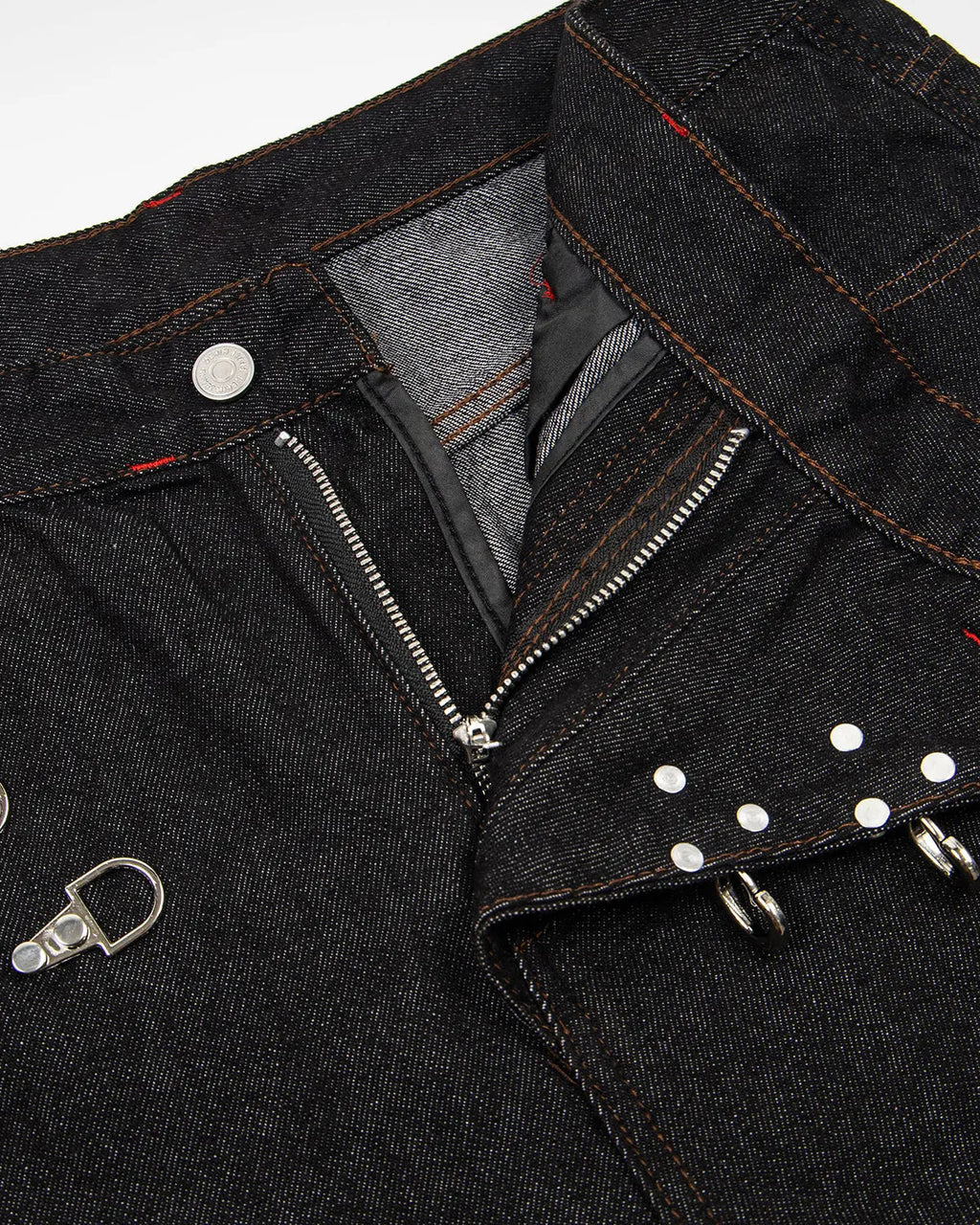 Black Flation asymmetric buckle raw baggy jeans with distressed details and relaxed fit, streetwear style.