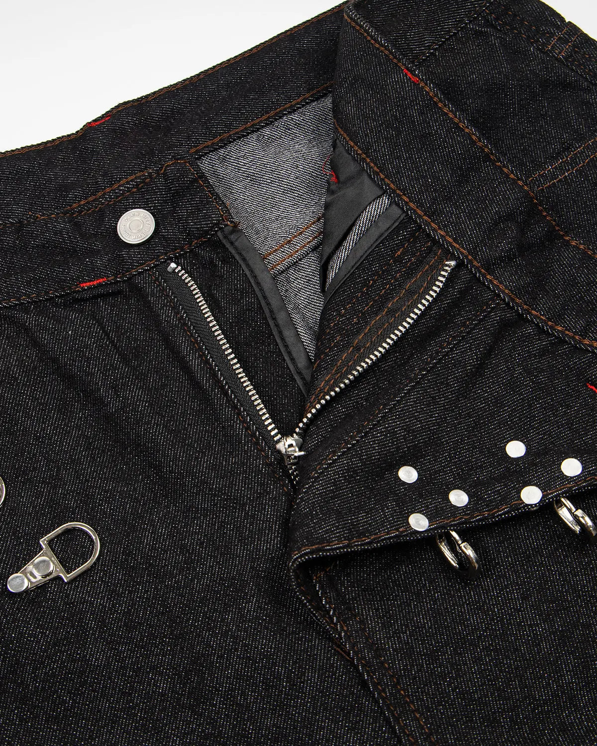 Black Flation asymmetric buckle raw baggy jeans with distressed details and relaxed fit, streetwear style.