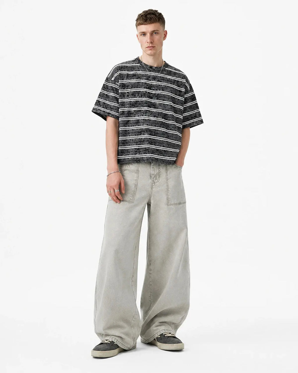 Deconstructed distressed barrel jeans by Flation Streetwear featuring ripped details and a relaxed fit, shown on a model.