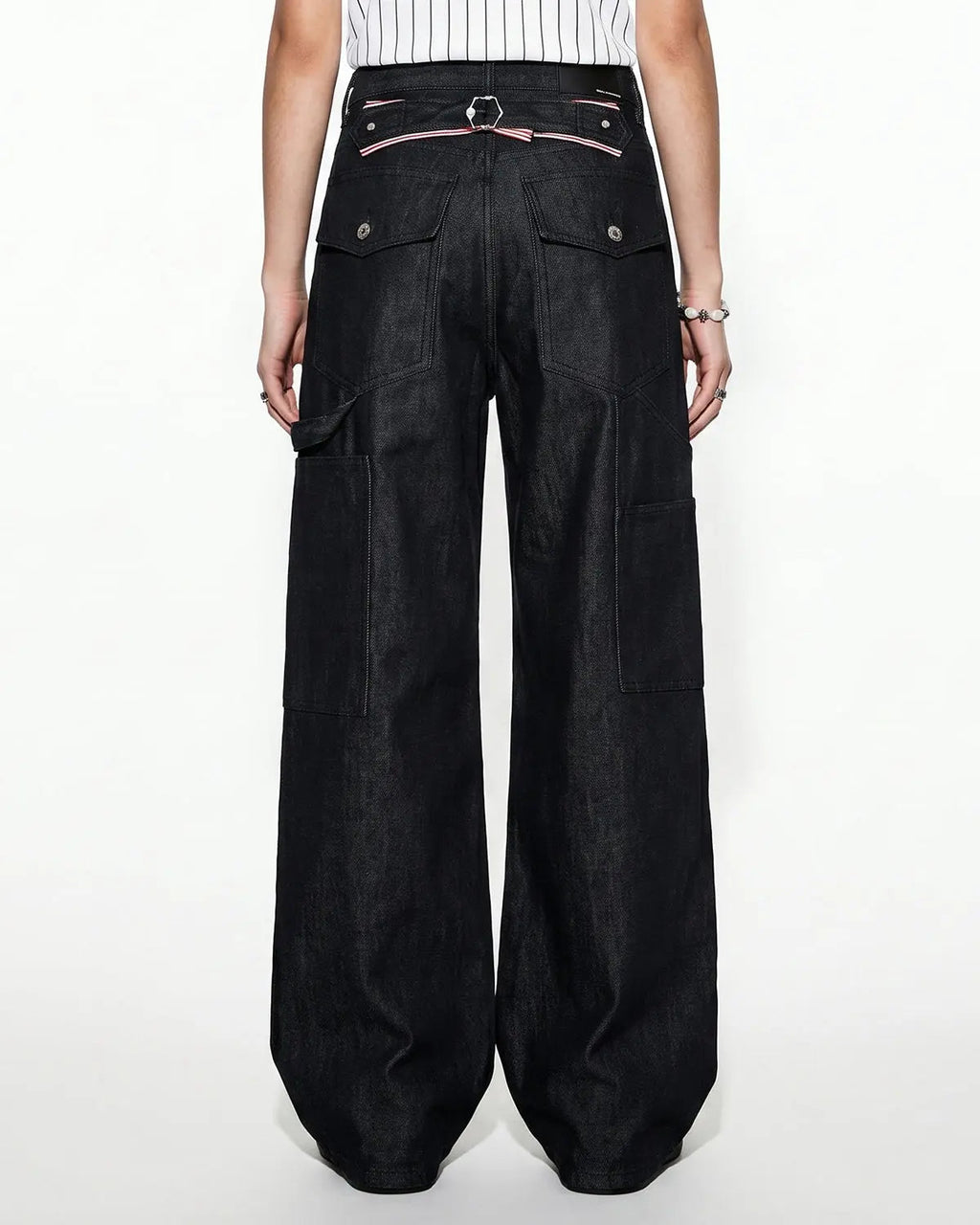 Black deconstructed utility baggy jeans by Flation Streetwear, featuring relaxed fit, multiple pockets, and casual street style.