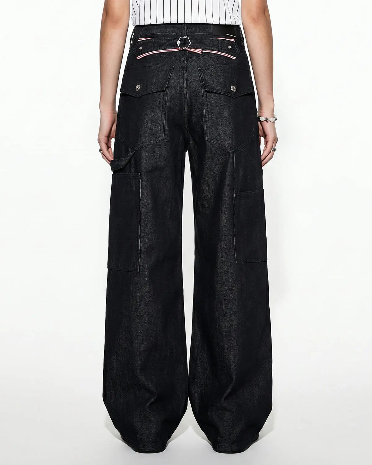 Black deconstructed utility baggy jeans by Flation Streetwear, featuring relaxed fit, multiple pockets, and casual street style.