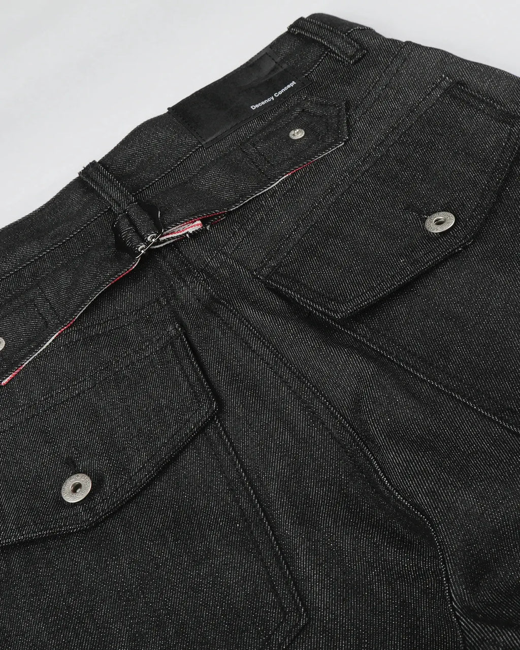 Black deconstructed utility baggy jeans by Flation Streetwear, featuring loose fit, multiple pockets, and rugged style.