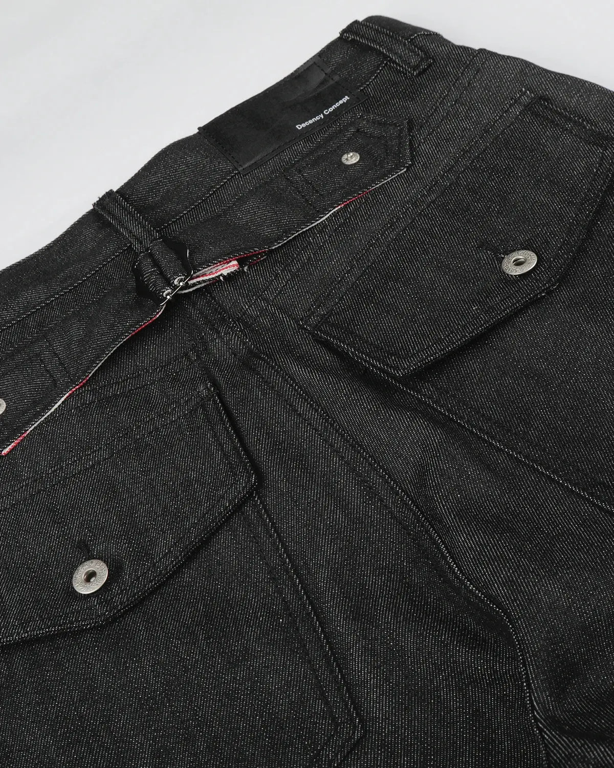 Black deconstructed utility baggy jeans by Flation Streetwear, featuring loose fit, multiple pockets, and rugged style.