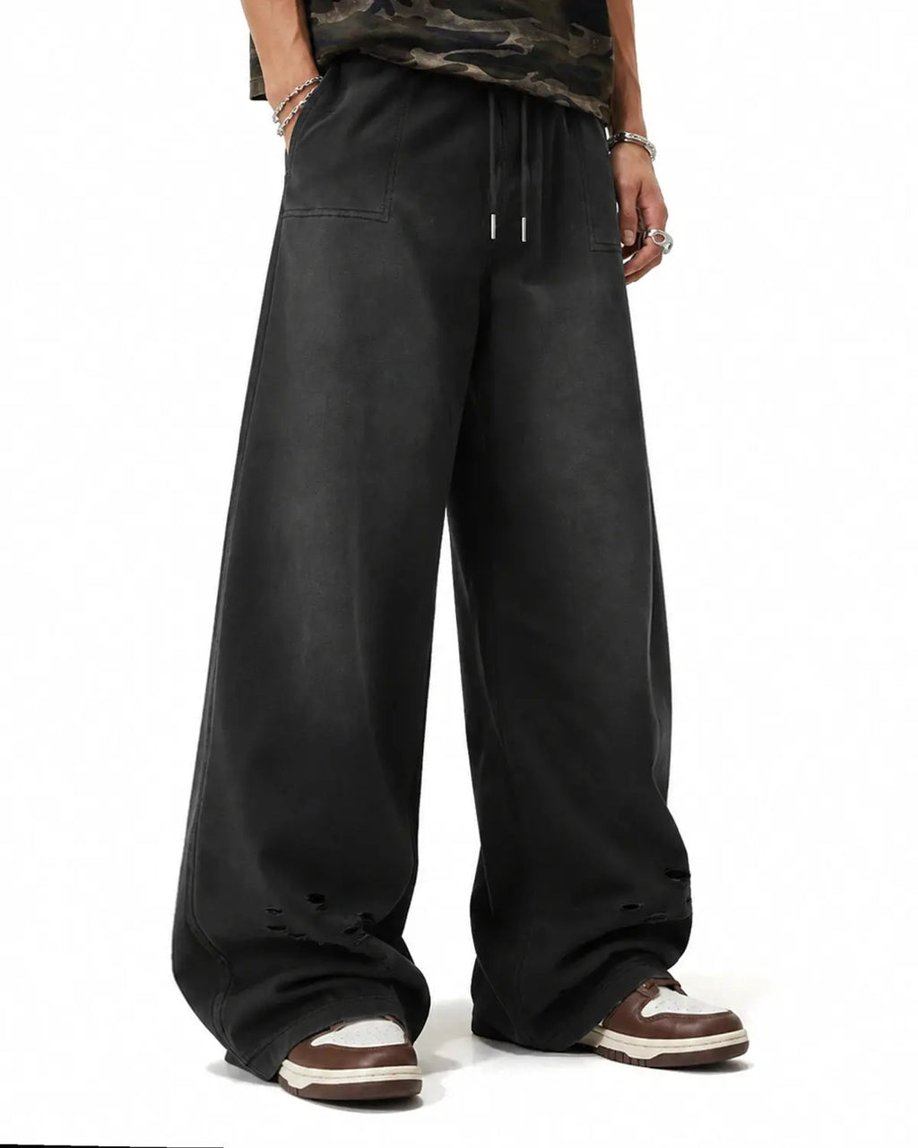 Black distressed washed baggy sweatpants by Flation Streetwear, relaxed fit with faded, rugged denim style.