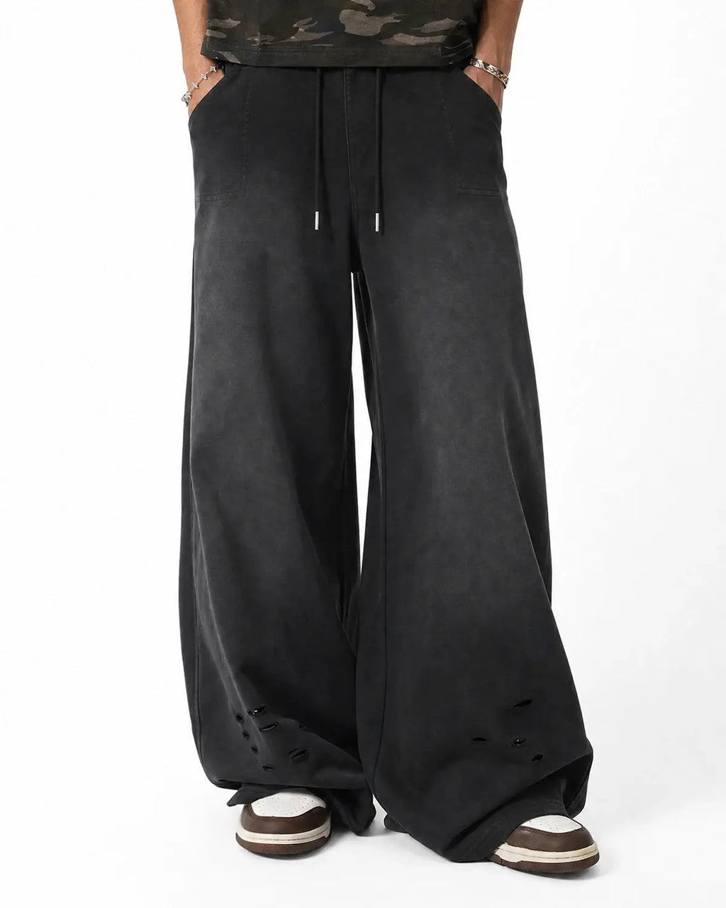 Black distressed washed baggy sweatpants by Flation Streetwear, relaxed fit with faded, worn-in style and comfortable fabric.