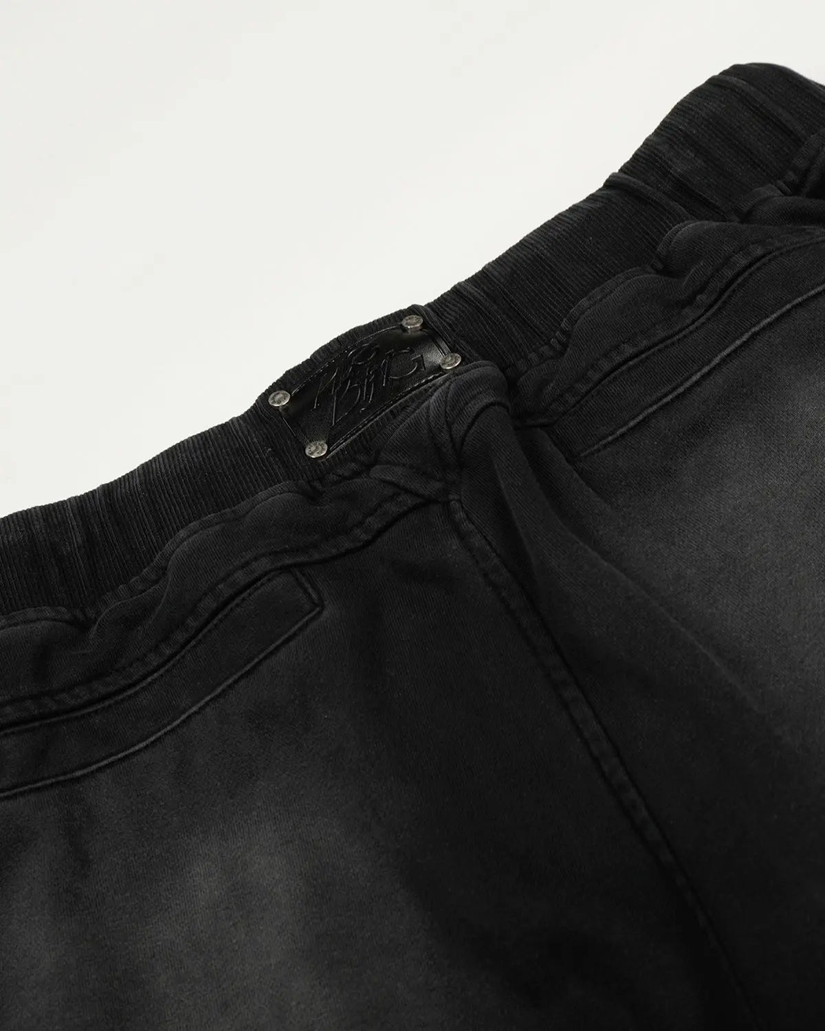 Black distressed washed baggy sweatpants by Flation Streetwear, relaxed fit with frayed details and casual style.