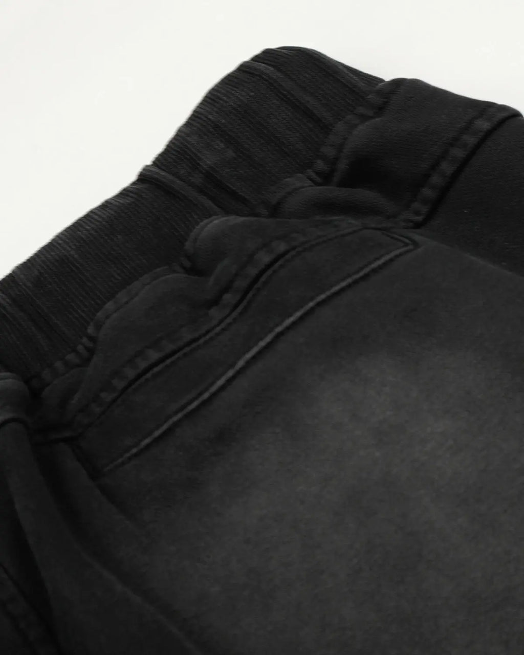 Black distressed washed baggy sweatpants by Flation Streetwear, featuring a relaxed fit and casual style.