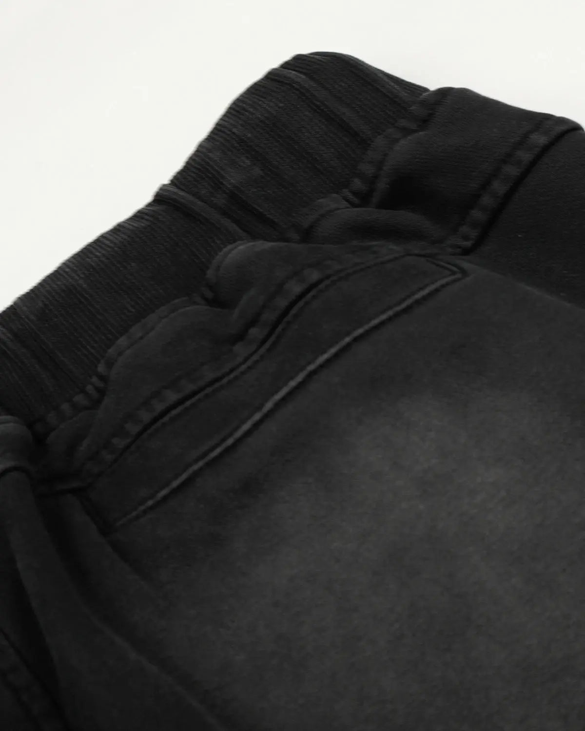 Black distressed washed baggy sweatpants by Flation Streetwear, featuring a relaxed fit and casual style.
