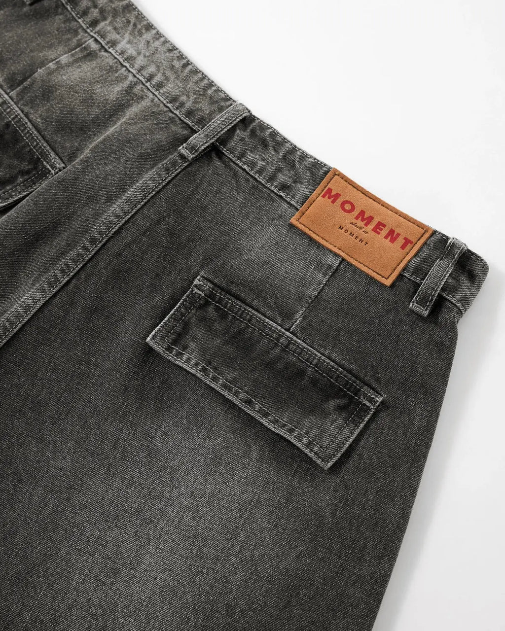 Black distressed washed cargo barrel jeans by Flation, featuring a relaxed streetwear style with rugged, faded denim details.