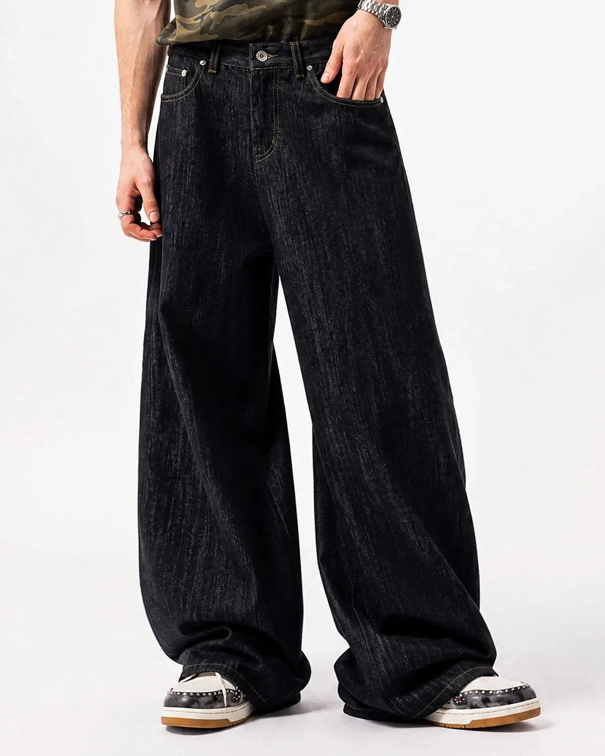 Black embroidered raw baggy jeans by Flation Streetwear, featuring loose fit and detailed embroidery on the denim fabric.