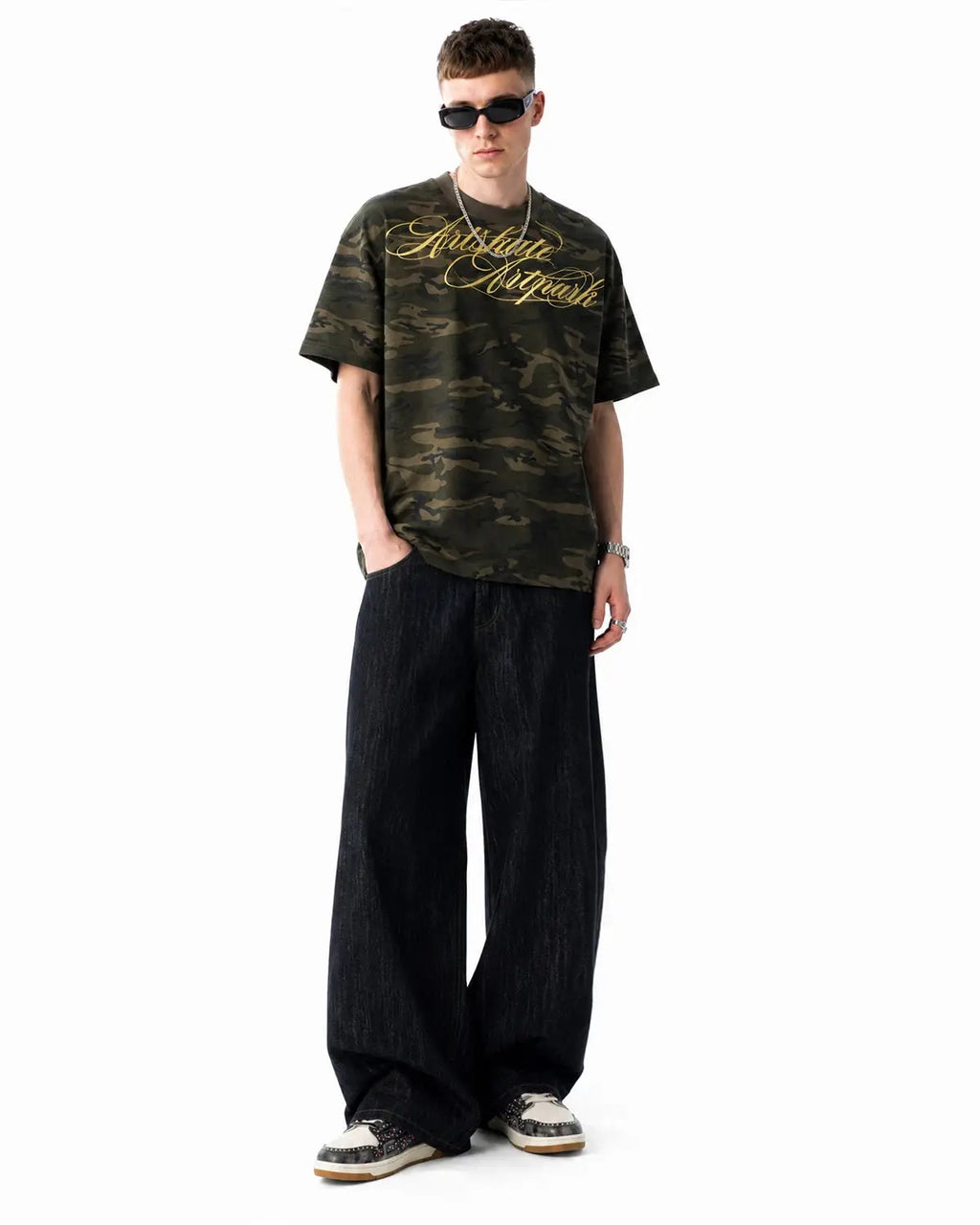 Black embroidered raw baggy jeans by Flation Streetwear with relaxed fit and detailed stitching, shown on a model.