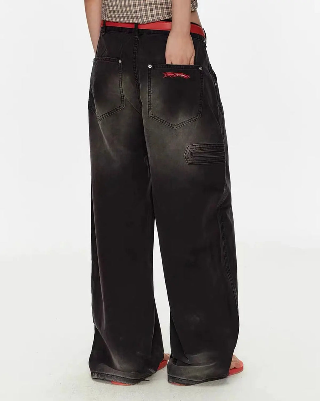 Retro washed wide-leg jeans from Flation Streetwear with distressed details and relaxed fit, displayed on a hanger.