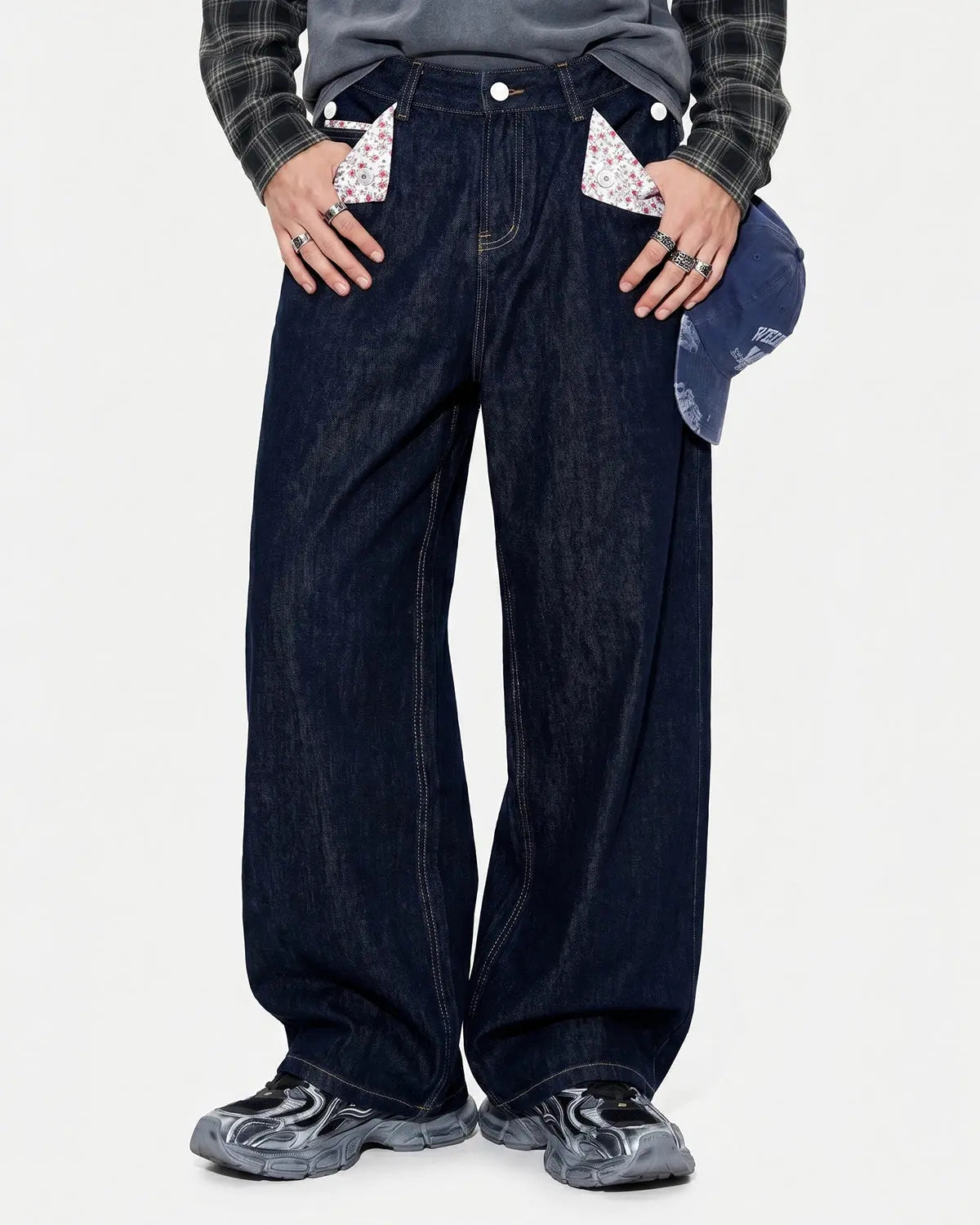 Selvedge Buckle Baggy Jeans by INFLATION, showcasing relaxed fit denim with a buckle detail and raw hem, streetwear style.