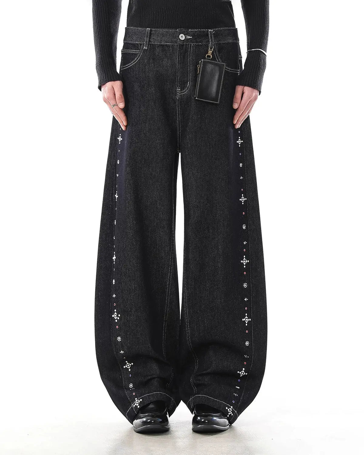 Black studded rhinestone baggy denim jeans by Flation Streetwear, featuring a relaxed fit and decorative rhinestone embellishments.