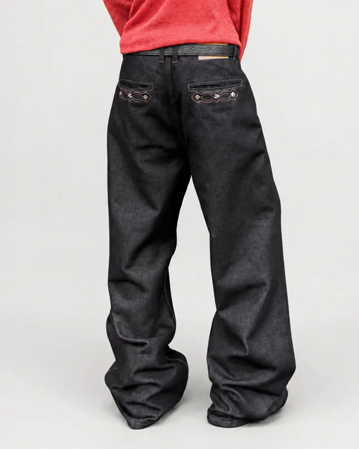 Black vintage embroidered bootcut jeans by Flation Streetwear, showing detailed embroidery and classic fit.