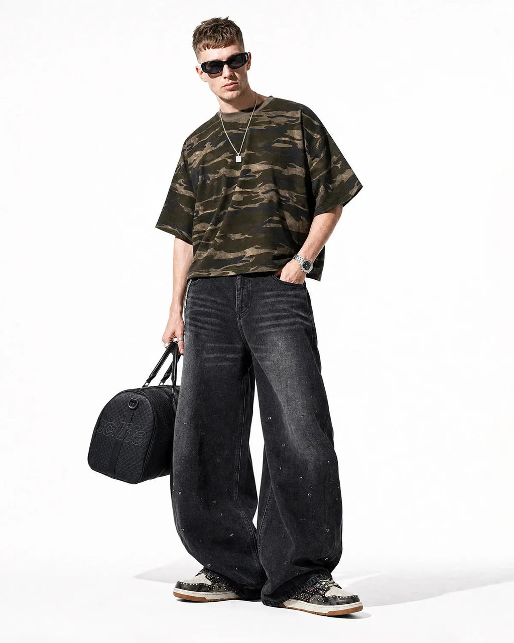Black vintage washed rhinestone barrel jeans by Flation Streetwear, featuring a relaxed fit and embellished rhinestone details.