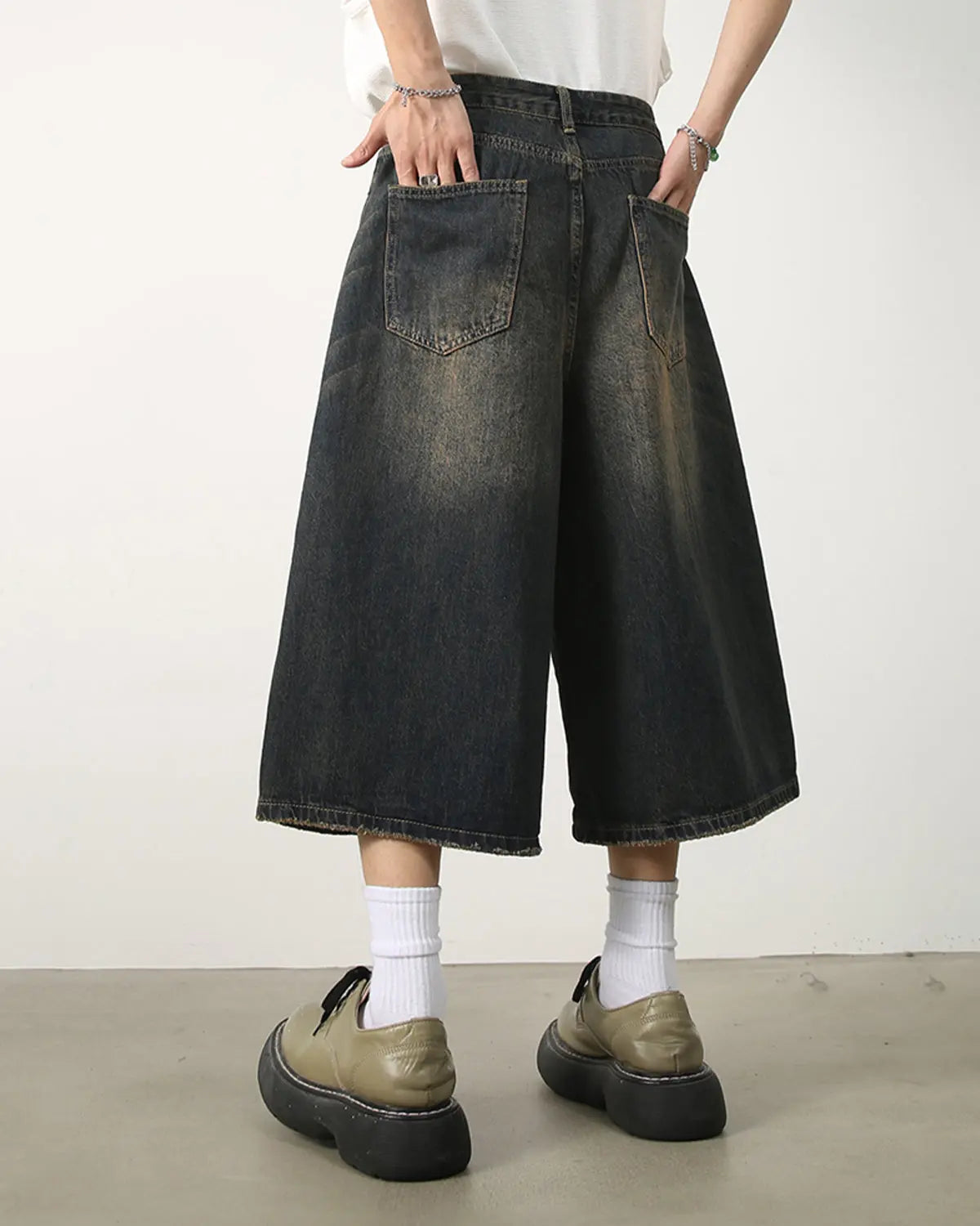 Black washed baggy denim jorts by Flation Streetwear, featuring a loose fit and distressed denim style.