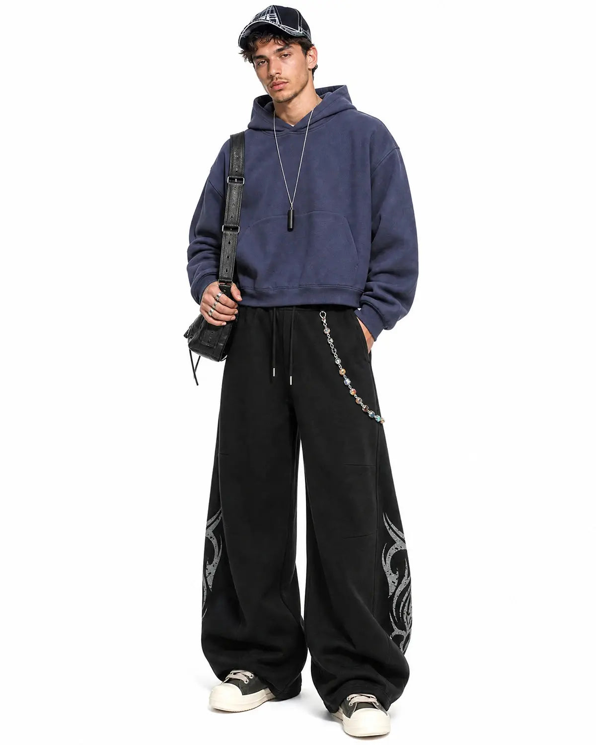 Black washed distressed barrel sweatpants by Flation Streetwear, featuring relaxed fit and casual streetwear style.