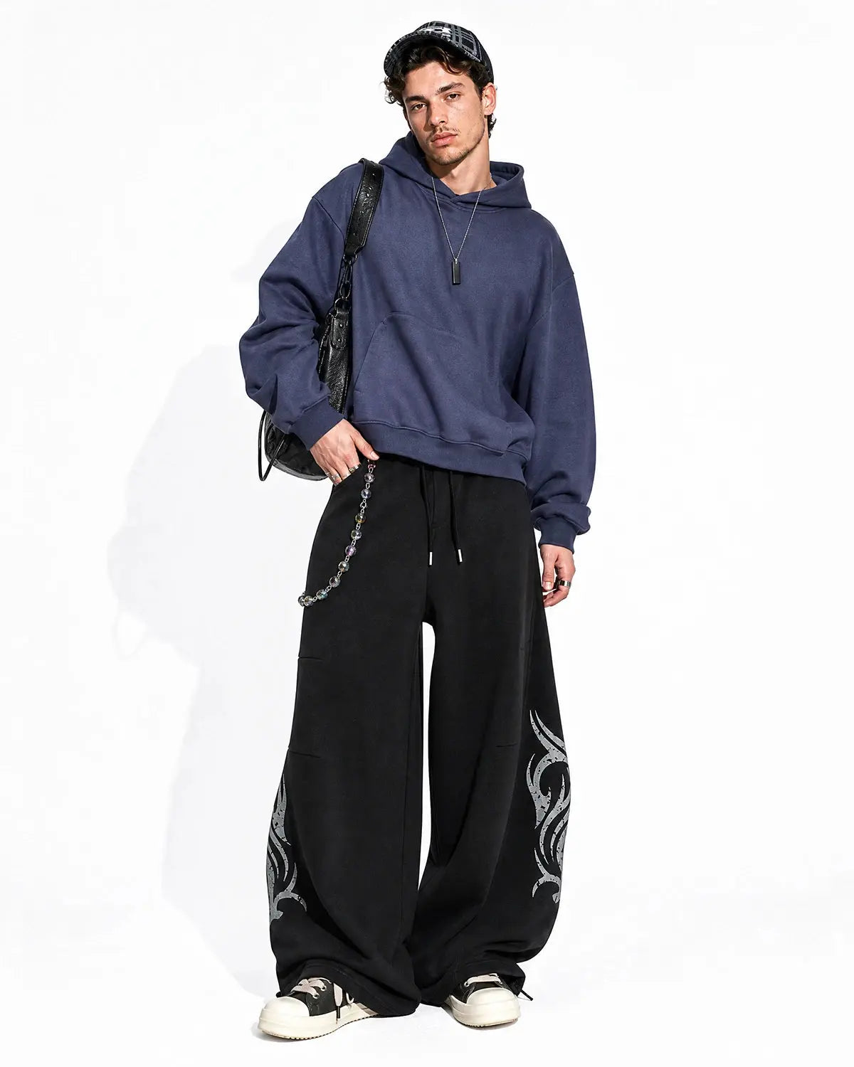 Black washed distressed barrel sweatpants by Flation Streetwear, featuring relaxed fit and stylish distressed details.