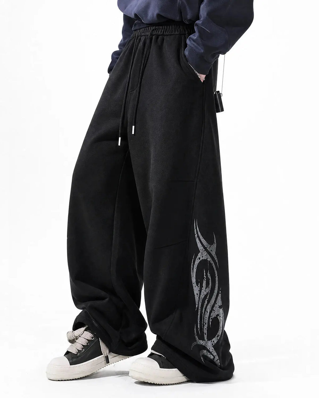 Black washed distressed barrel sweatpants by Flation Streetwear, featuring relaxed fit and casual, urban style.