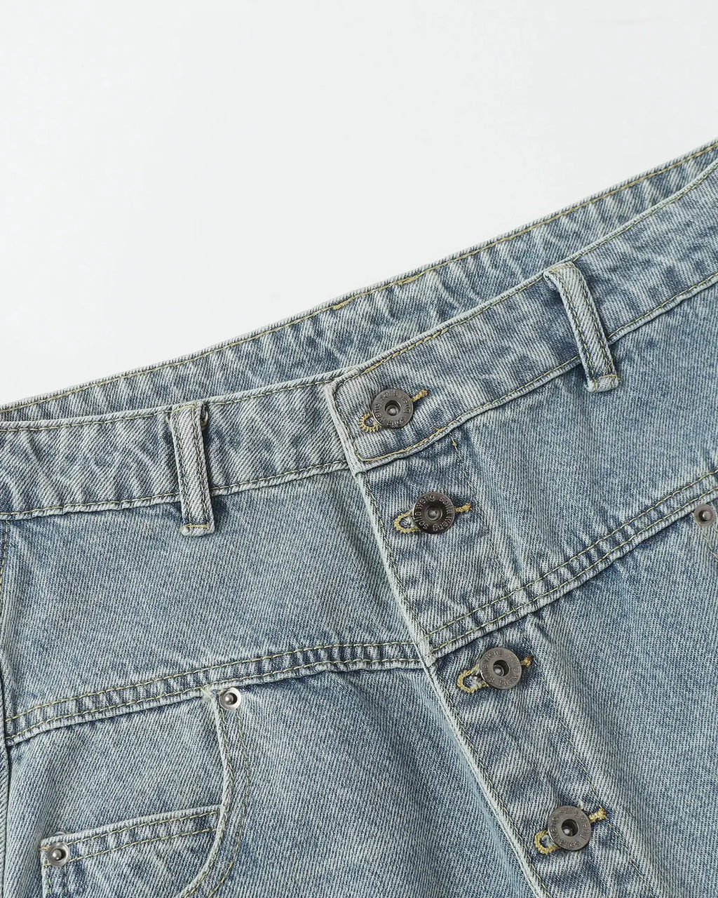 Blue asymmetric button baggy jeans by Flation Streetwear featuring relaxed fit and stylish streetwear design.