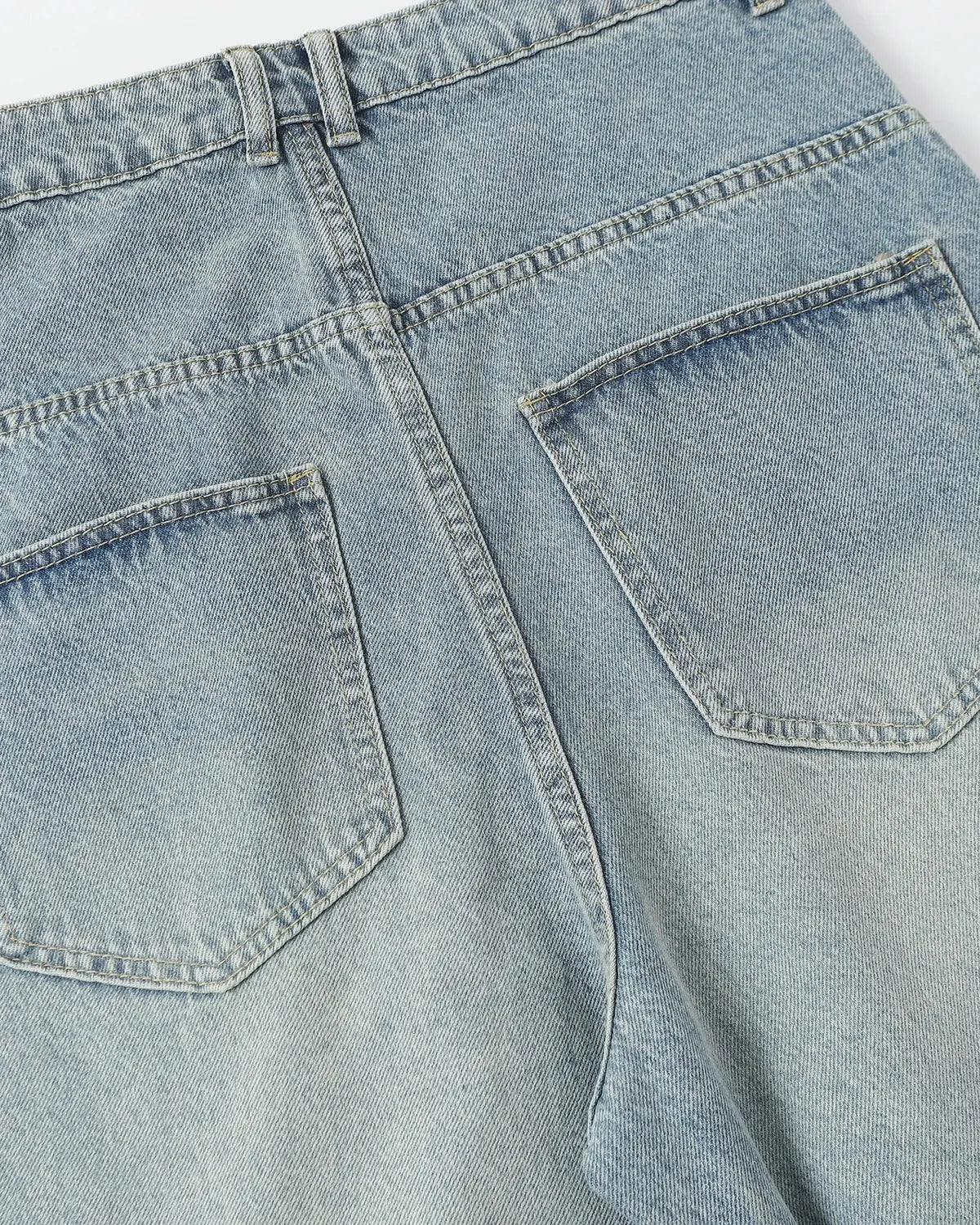Blue asymmetrical button baggy jeans by Flation Streetwear, featuring loose fit, stylish design, and casual streetwear style.