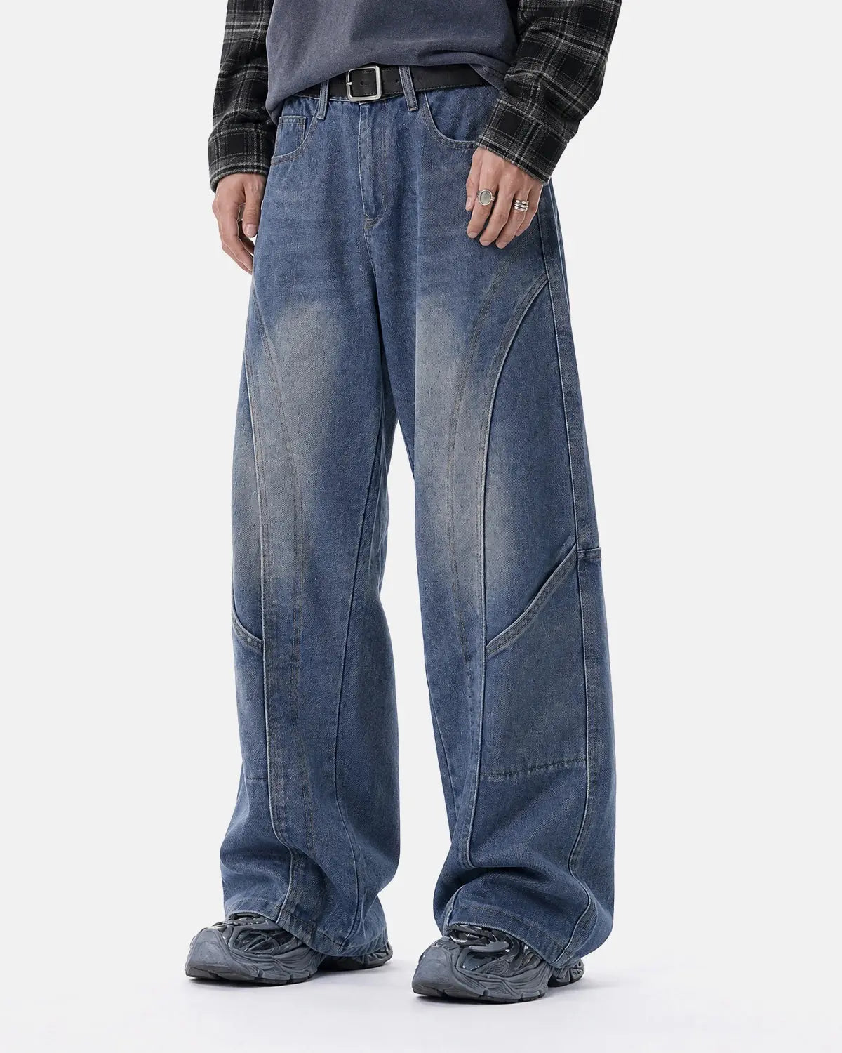 Deconstructed baggy straight-leg jeans by INFLATION, showing distressed denim and relaxed fit with frayed hems and casual style