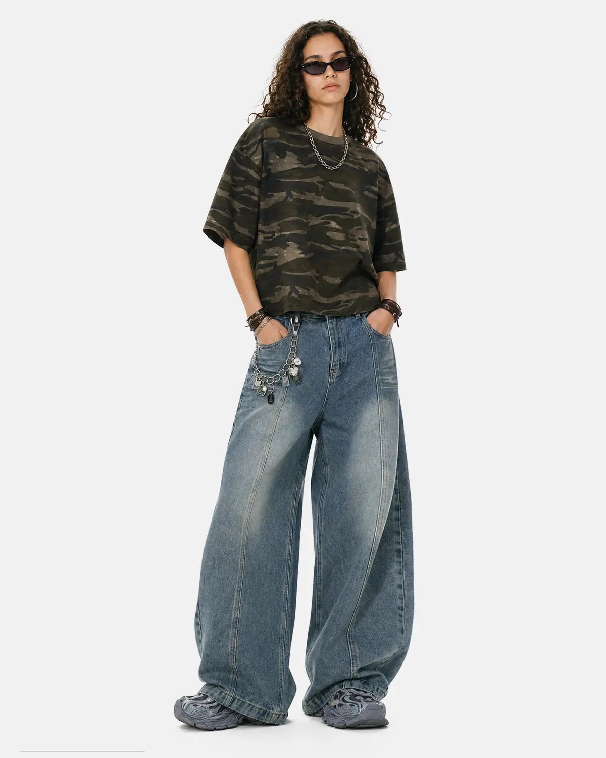 Light blue deconstructed washed barrel jeans by Flation Streetwear, featuring distressed details and relaxed fit style.