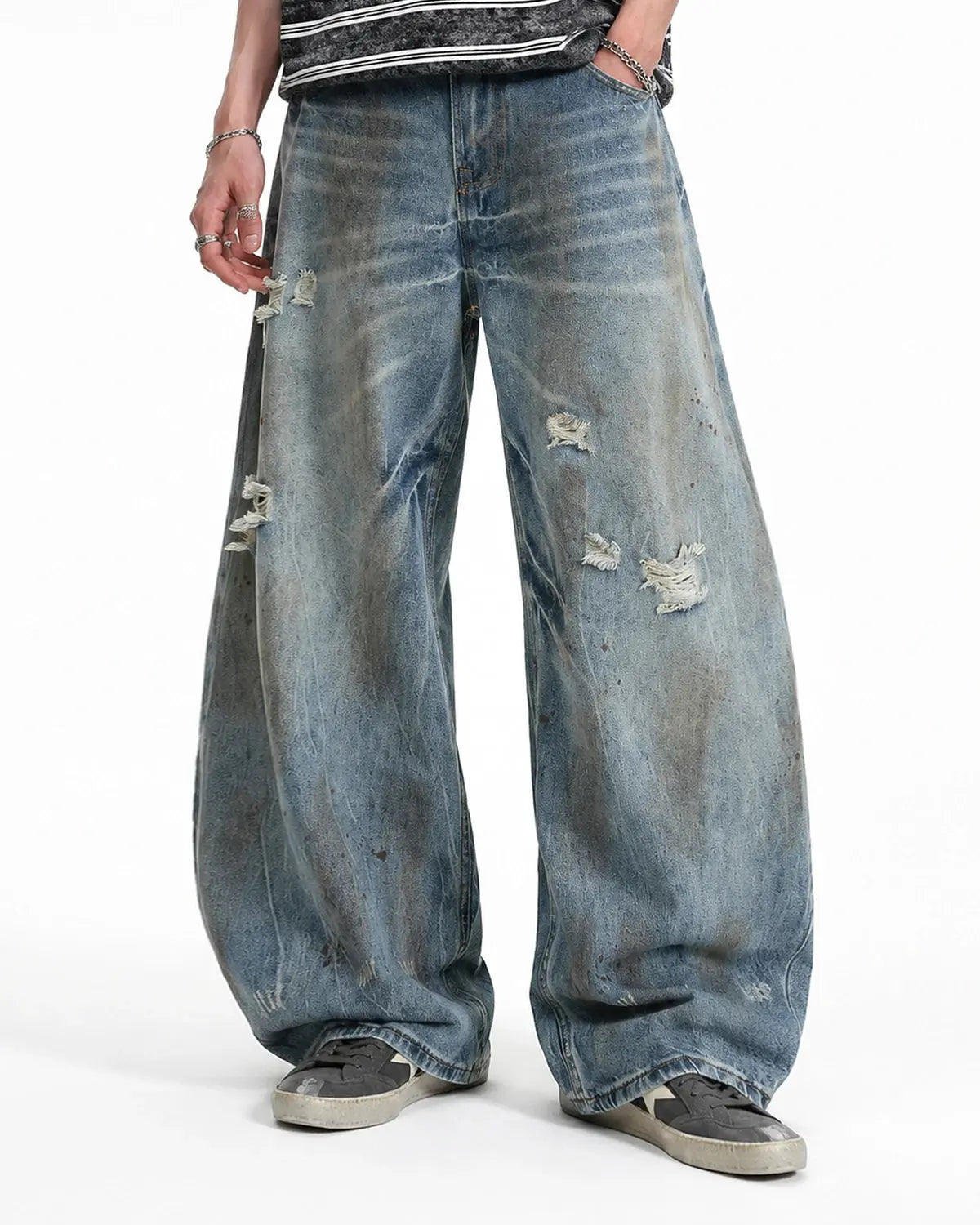 Distressed barrel jeans by INFLATION featuring a washed, rugged look with distressed details and a relaxed fit.