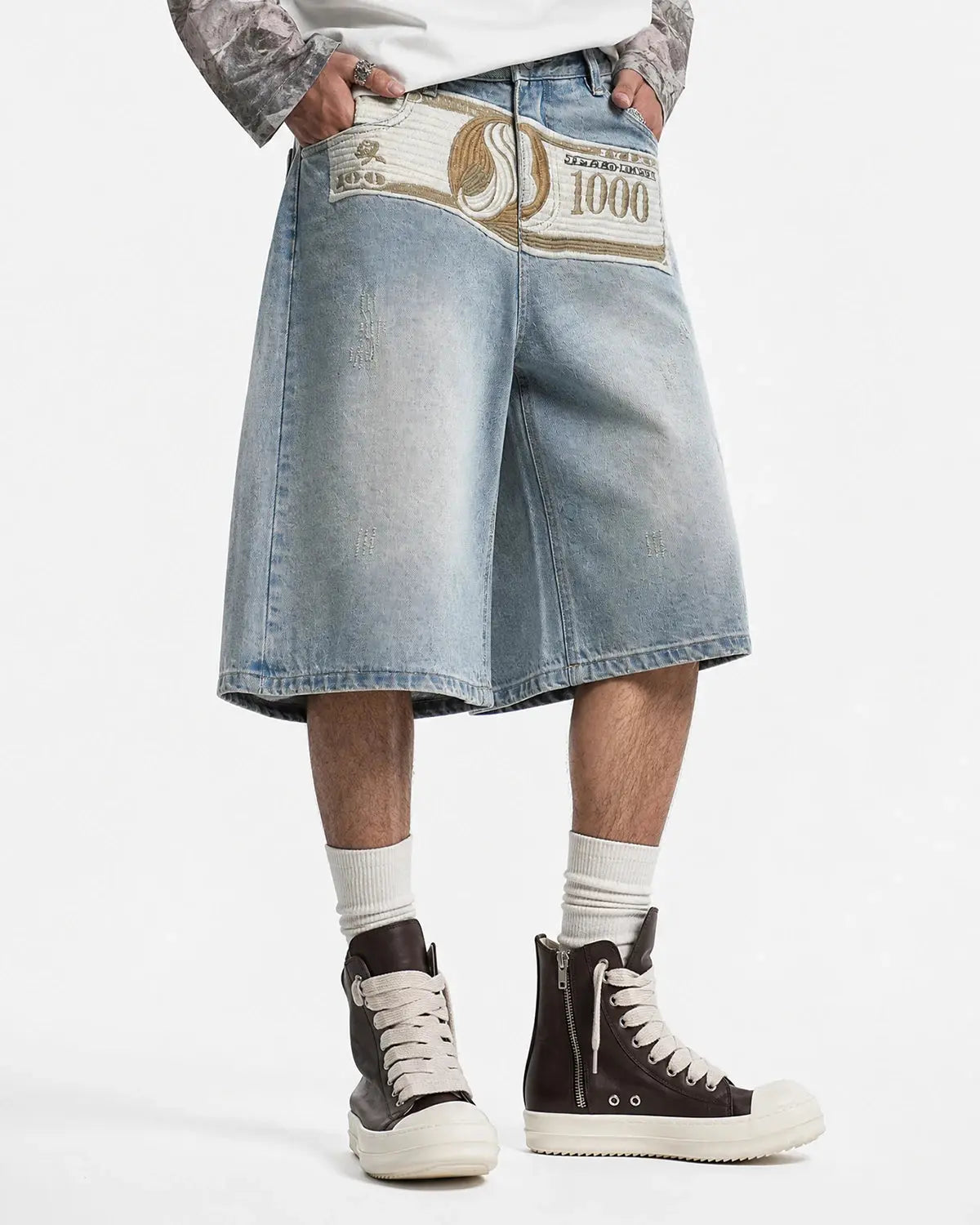 Blue denim jorts with dollar patch embroidery by Flation Streetwear, featuring frayed hems and streetwear style.