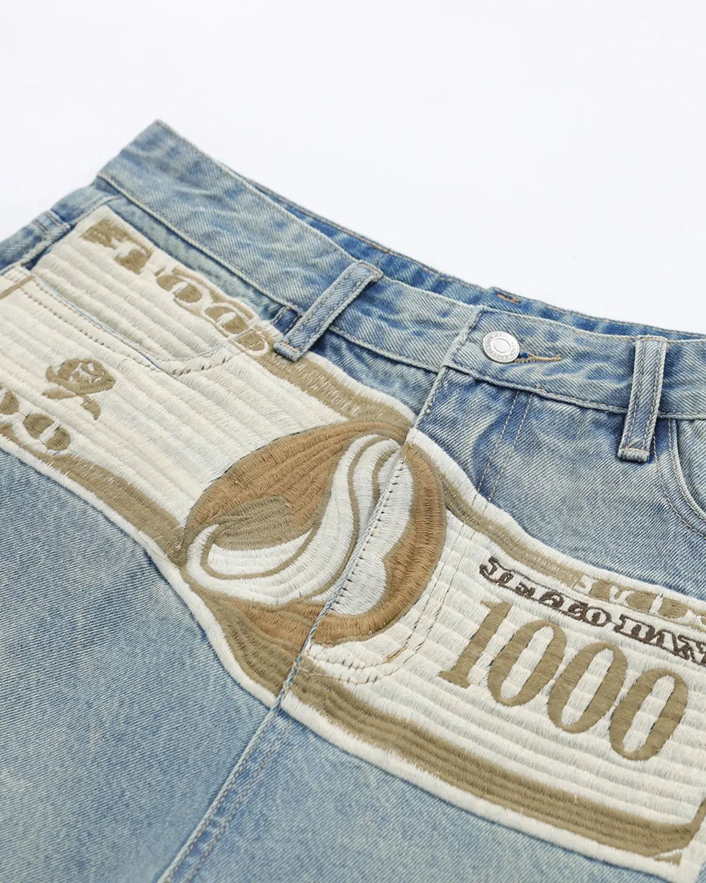Blue denim Jorts with dollar patch embroidery by Flation Streetwear, showcasing distressed hem and casual streetwear style