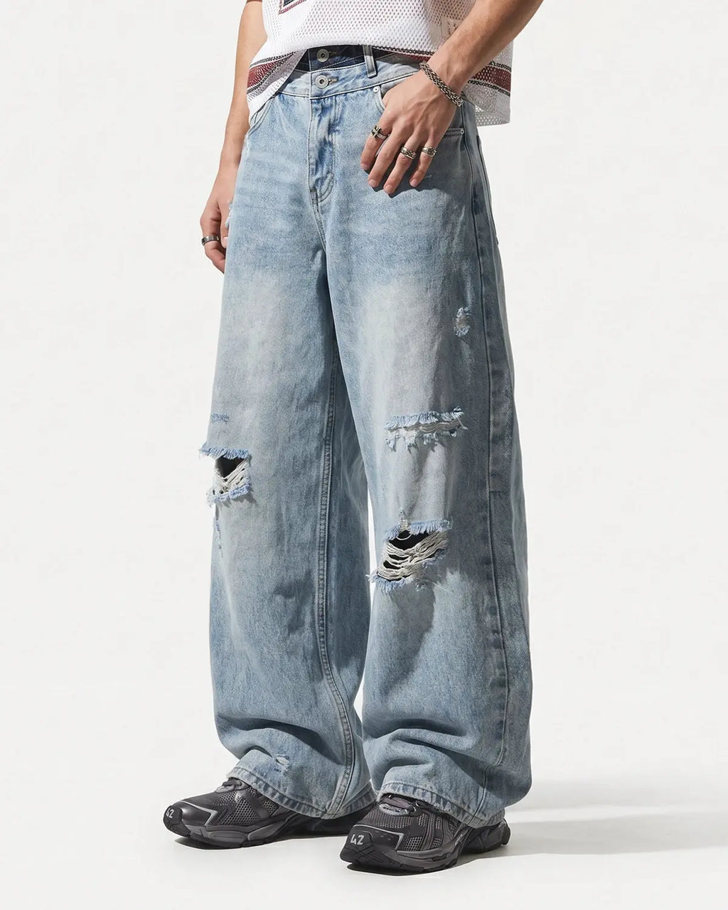 Blue double waist distressed baggy jeans by Flation Streetwear with a relaxed fit and rugged distressed details.