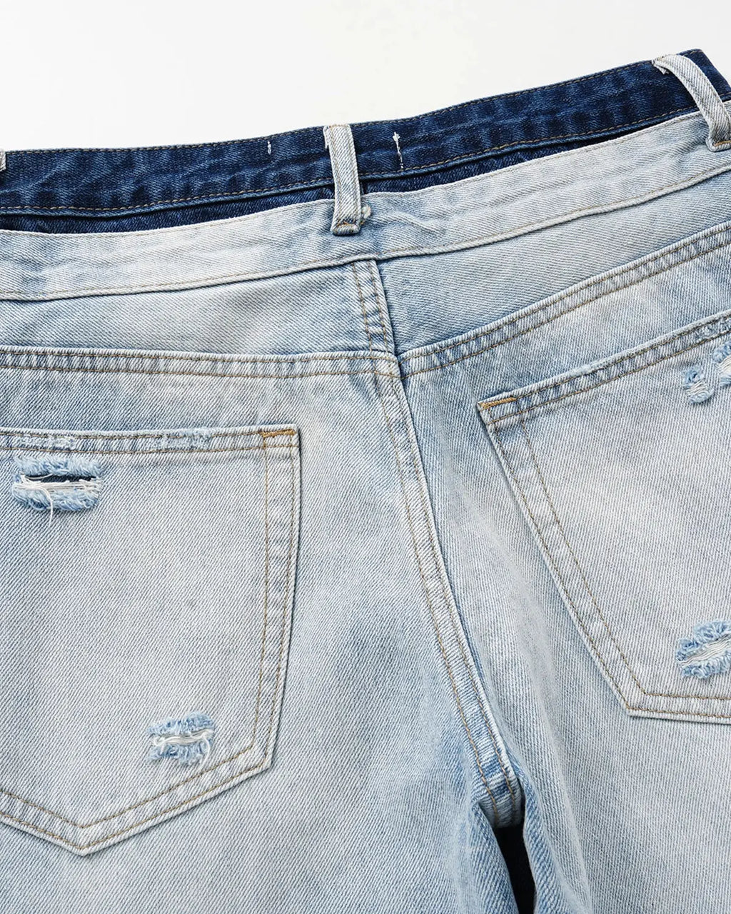 Blue double waist distressed baggy jeans by Flation Streetwear, featuring a relaxed fit and ripped details.