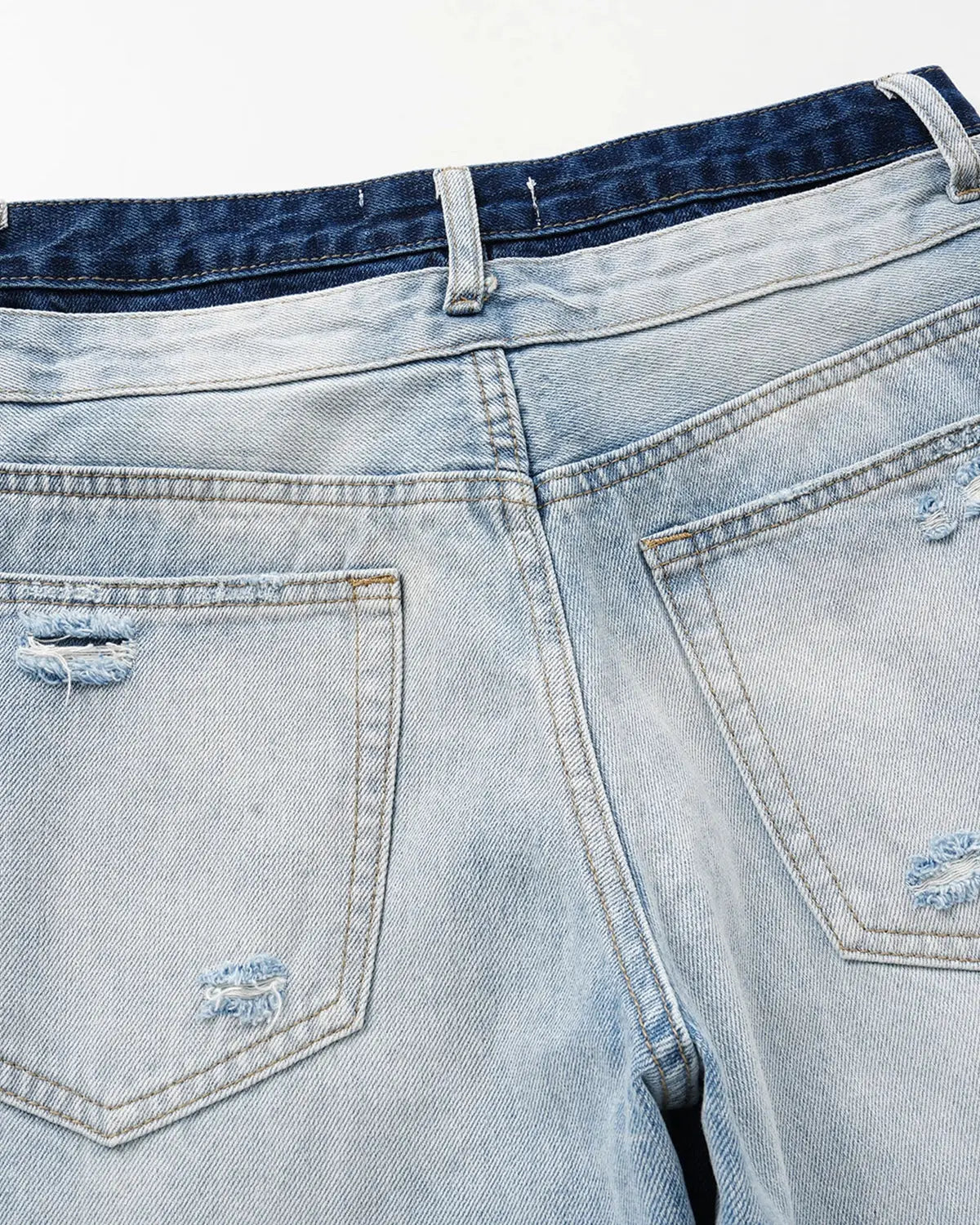 Blue double waist distressed baggy jeans by Flation Streetwear, featuring a relaxed fit and ripped details.