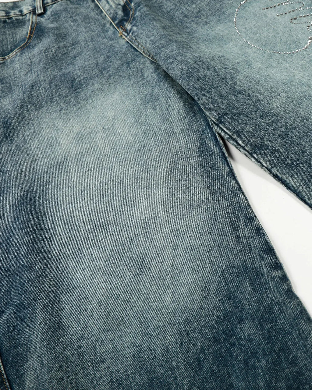 Blue rhinestone acid wash baggy jeans by Flation Streetwear, featuring a relaxed fit and sparkling rhinestone accents.