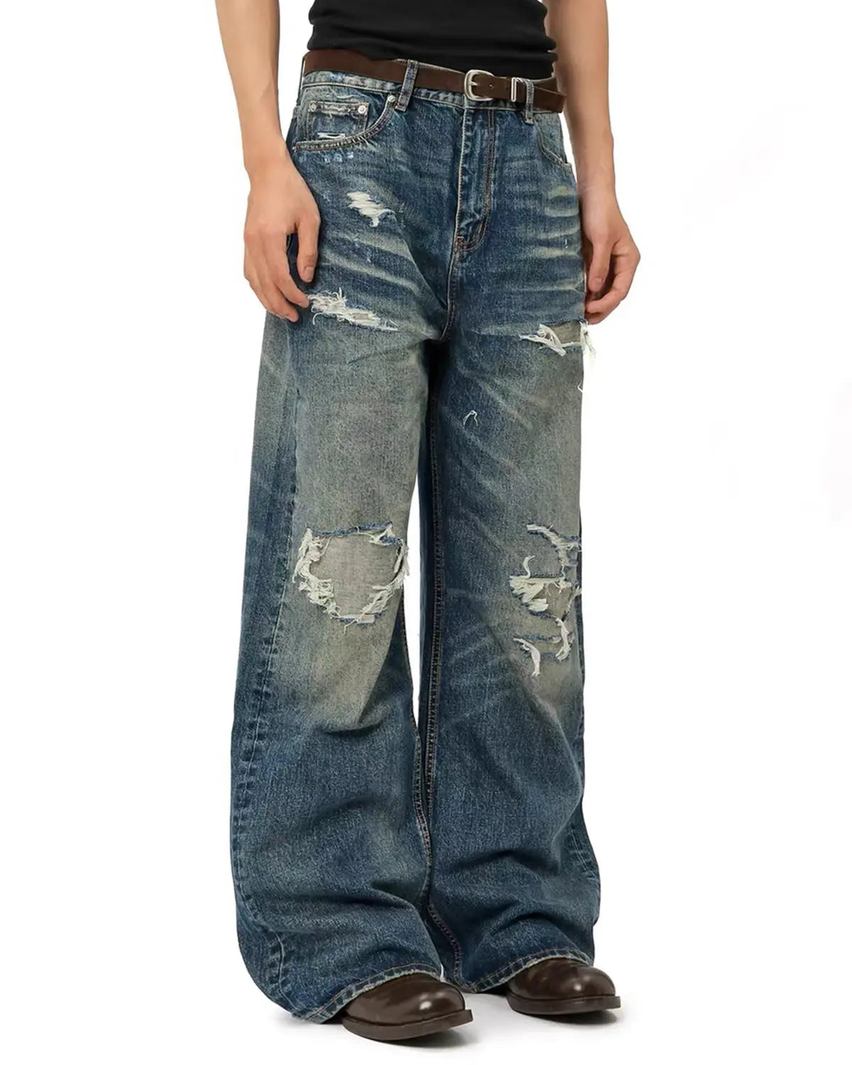 Blue vintage distressed baggy jeans by Flation Streetwear, relaxed fit with faded and ripped details.