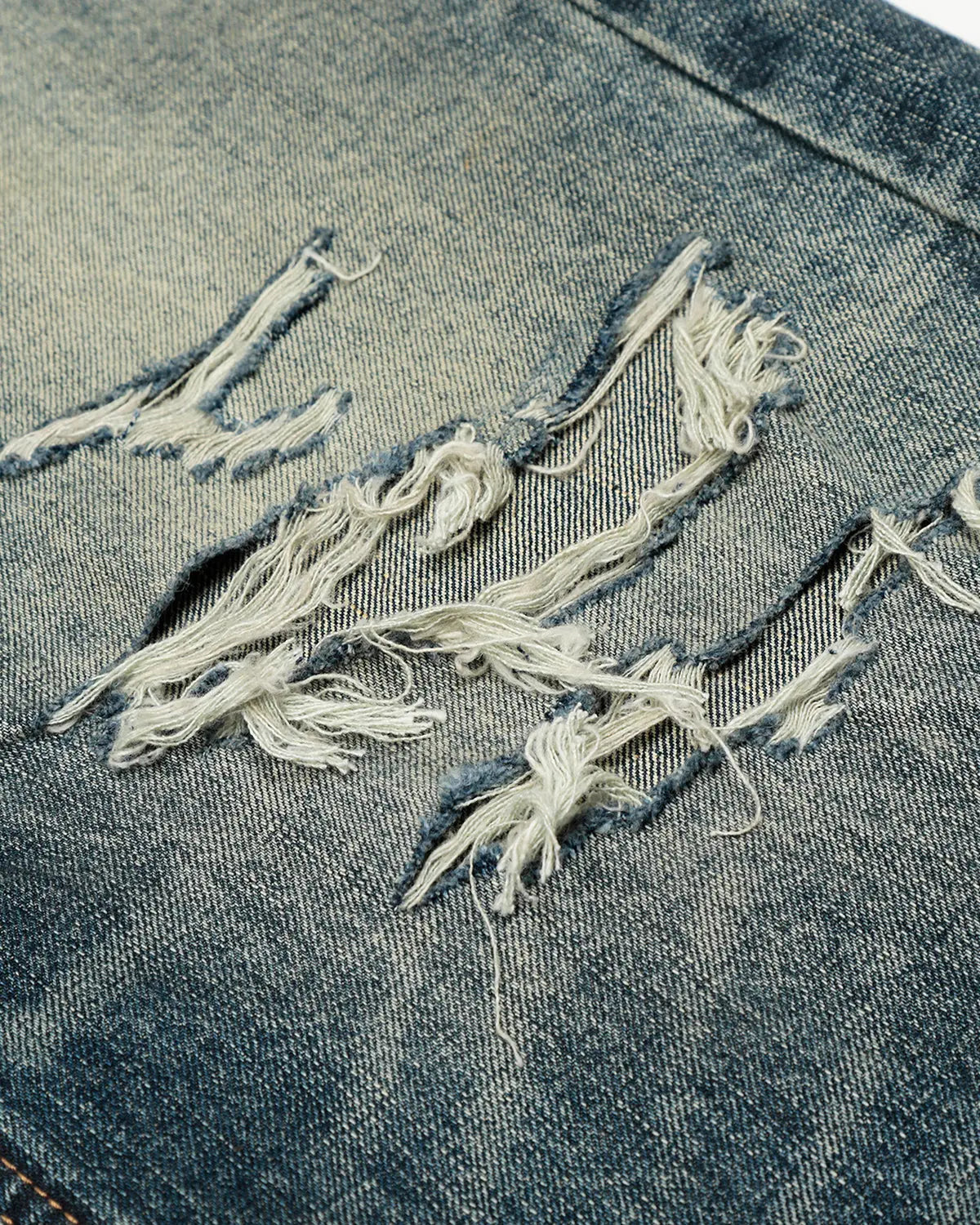 Blue vintage distressed baggy jeans by Flation Streetwear, featuring a relaxed fit and worn-in denim look.
