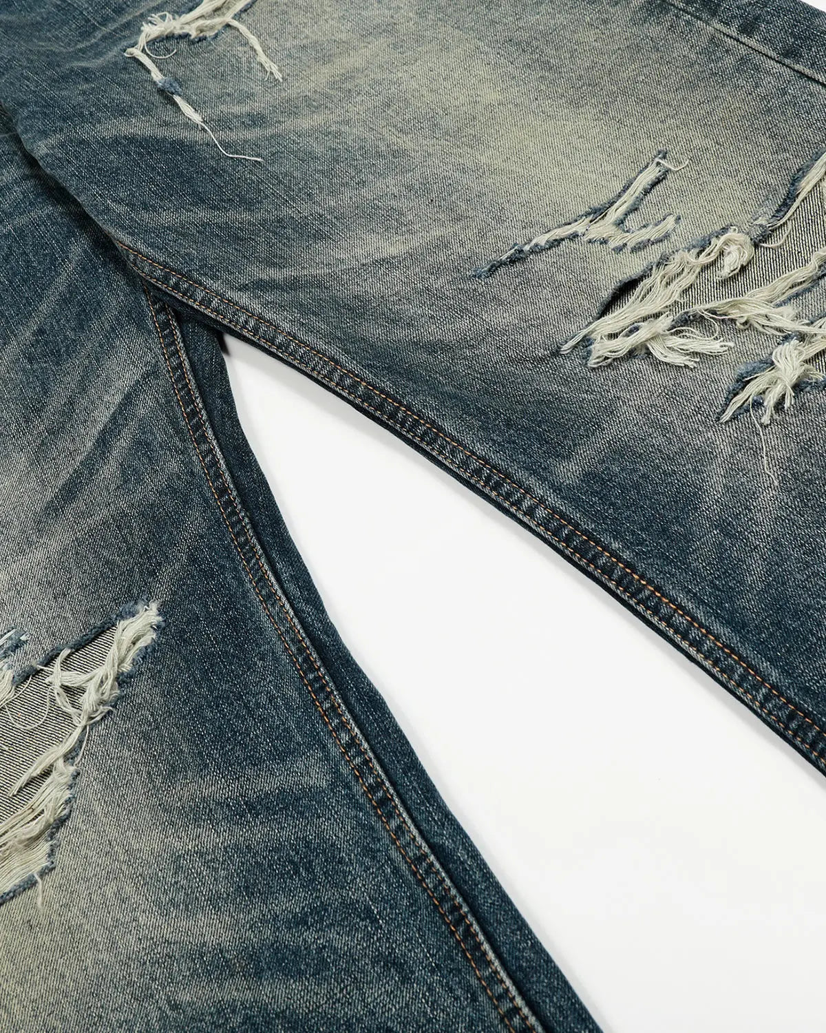 Blue vintage distressed baggy jeans by Flation Streetwear, featuring a relaxed fit and worn-in denim style.