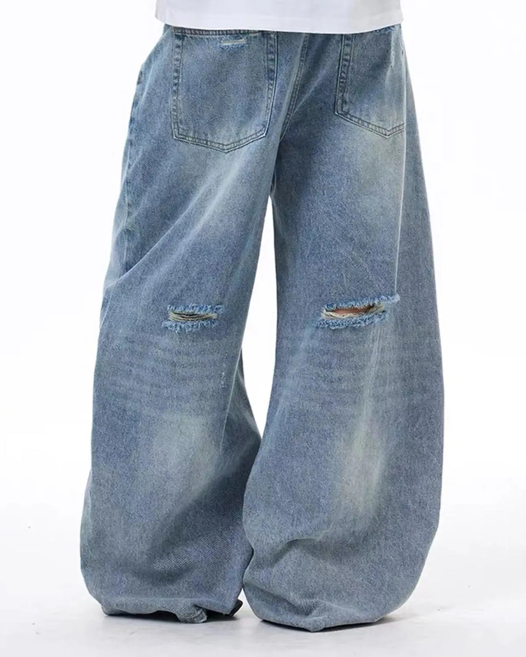 Blue vintage wash distressed baggy jeans by Flation, featuring a relaxed streetwear style with faded and ripped details.